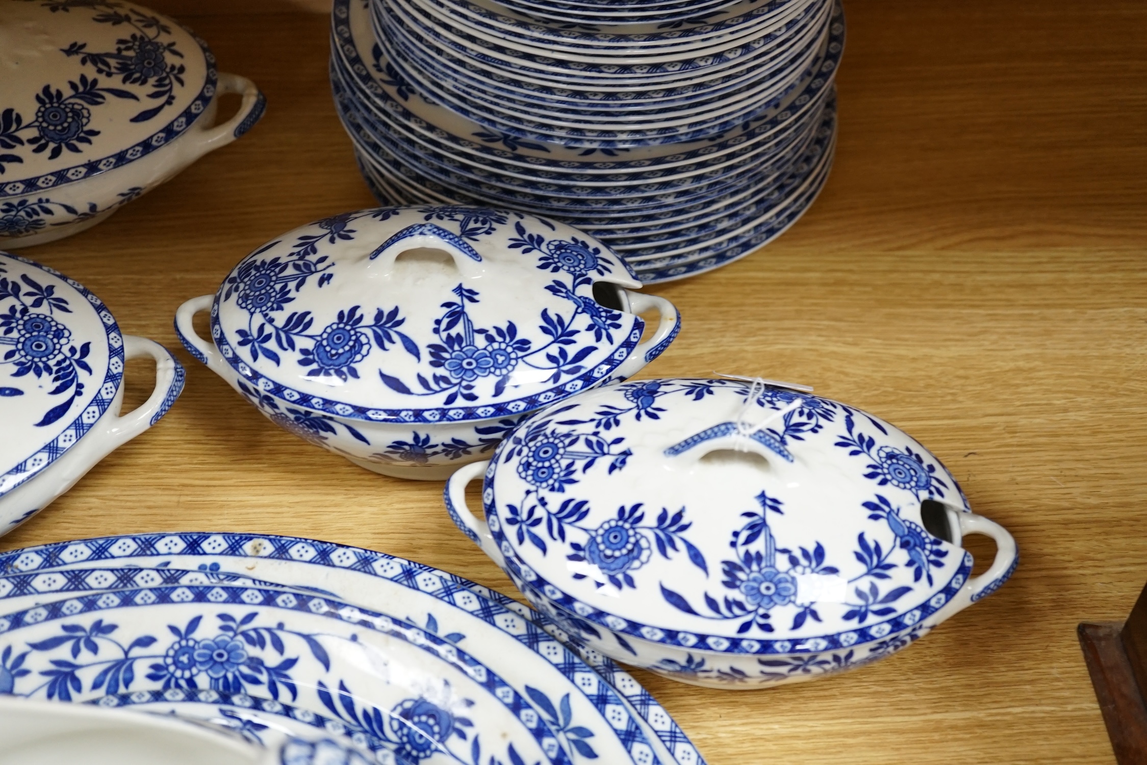 A mixed Wood and Sons ‘Delph’ patterned blue and white dinner service, including oval meat platters, various sized plates and two pairs of tureens and covers. Condition - fair to good